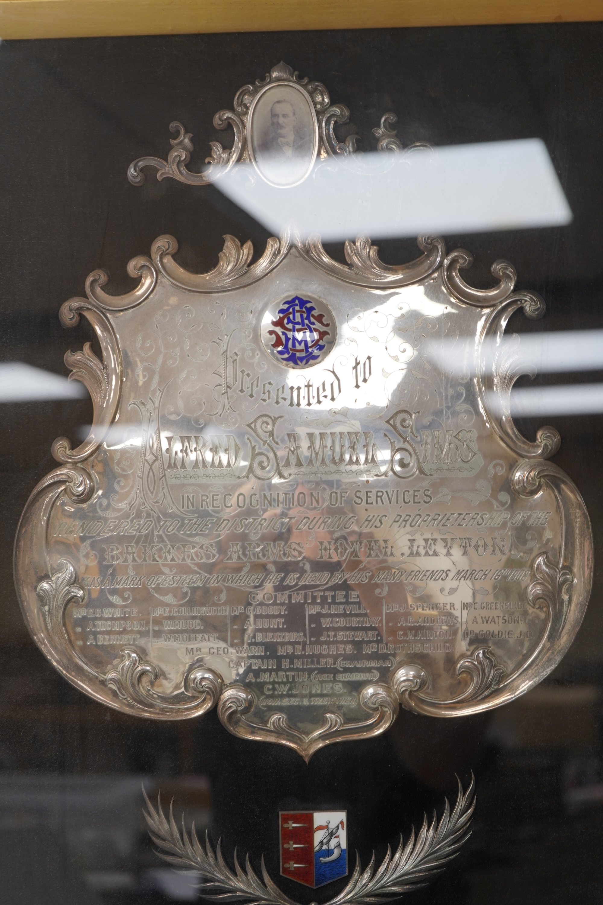 Alfred Samuel Sims commemorative plaque for his services to the Bakers Arms Hotel, with enamel decoration, framed, 60cm high